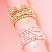 duo pearl bow bracelet stack in gold and silver