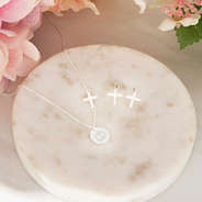 silver necklace set on marble