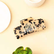 tortoise hair clip on tan background