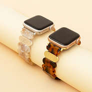 ivory and tortoise scallop watch band on tan paper roll