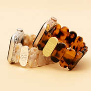 ivory and tortoise scalloped watch band on tan paper