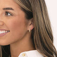 girl wearing pave cable hoop earrings