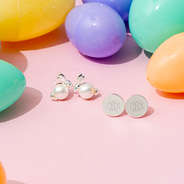 Bunny earrings with Easter eggs on pink background