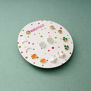 monogrammed year round earring set on green paper