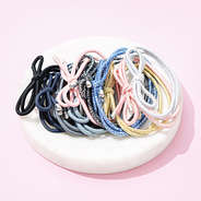 hair ties with pink background and white dish