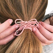 pink bow tie elastic hair ties in blonde hair