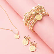 bow dangle earrings with pearl necklace and pearl bow bracelet stack