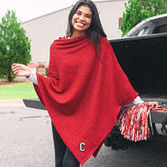 college of charleston fan wearing crimson poncho leaning on truck