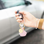 pink airtag key chain in hand