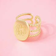 gold statement personalized ring on pink background