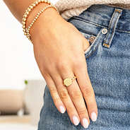 gold chain link ring with hand in pocket