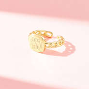 gold chain link ring on pink background