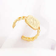 gold chain link ring on white cloth