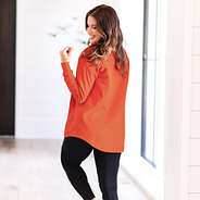 side of peyton in orange quarter zip sweatshirt