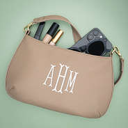 close up of monogrammed taupe shoulder bag
