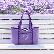 purple anywhere tote bag on bench with flowers