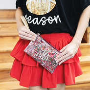 girl carrying crimson glitter personalized wristlet pouch