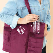 burgundy pocket tote bag on shoulder with water bottle