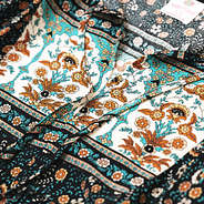 close up of black paisley puff sleeve dress