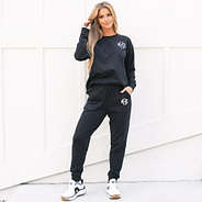 girl wearing monogrammed black joggers and sweatshirt