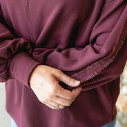 burgundy accent sleeve sweatshirt up close