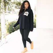 girl wearing black grid fleece pullover with leggings
