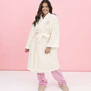 girl wearing monogrammed ivory plush robe