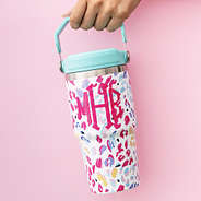 monogrammed flip top tumbler being carried by handle