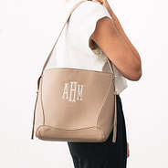 personalized bucket bag in taupe over shoulder