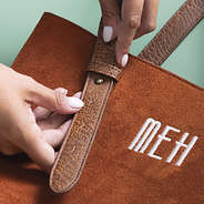 close up of suede purse adjustable strap