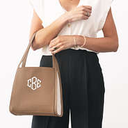 monogrammed shoulder tote in brown over arm