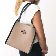 monogrammed shoulder tote in tan over shoulder