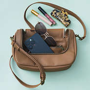 pockets in monogrammed crossbody bag in brown