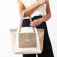 taupe colorblock tote bag on arm with split initials