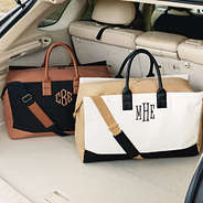 black and ivory monogrammed upscale weekenders in car
