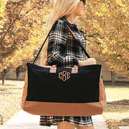 black monogrammed upscale weekender over shoulder