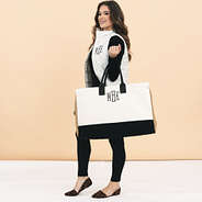 girl carrying personalized upscale ivory weekend bag over arm