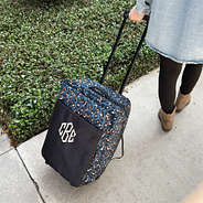 sapphire leopard rolling duffel bag on sidewalk