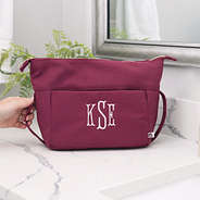 Burgundy Woodland Blossom foldover cosmetic case closed on counter