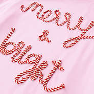 close up of light pink merry and bright sweatshirt