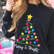 close up of black merry and bright pom pom sweatshirt
