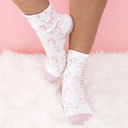 girl wearing pink bow socks on rug