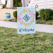 easter monogrammed garden flag next to sidewalk