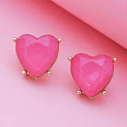 heart stud earrings on pink paper
