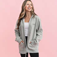 girl wearing grey monogrammed hooded sweatshirt jacket