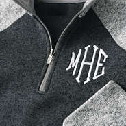 close up of monogrammed colorblock quarter zip fleece pullover in heathered charcoal