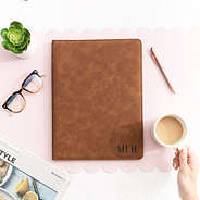 monogrammed leather portfolio on desk