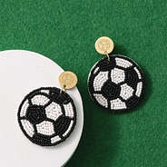 monogrammed soccer earrings on turf background