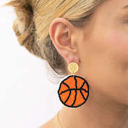 girl wearing monogrammed basketball earrings in ear