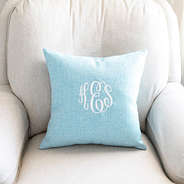 light blue linen pillow case on neutral chair